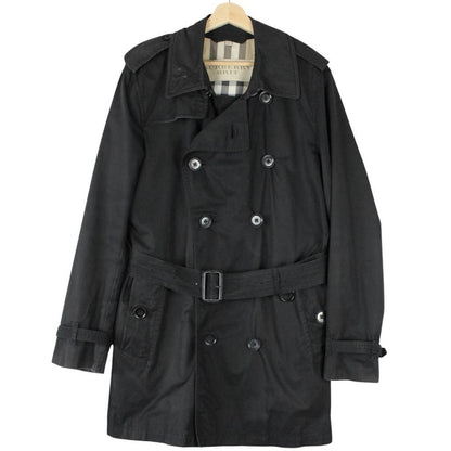 Burberry black trench coat featuring Nova Check pattern, double-breasted design, and belted waist.