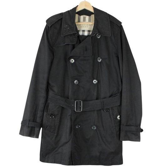 Burberry black trench coat featuring Nova Check pattern, double-breasted design, and belted waist.
