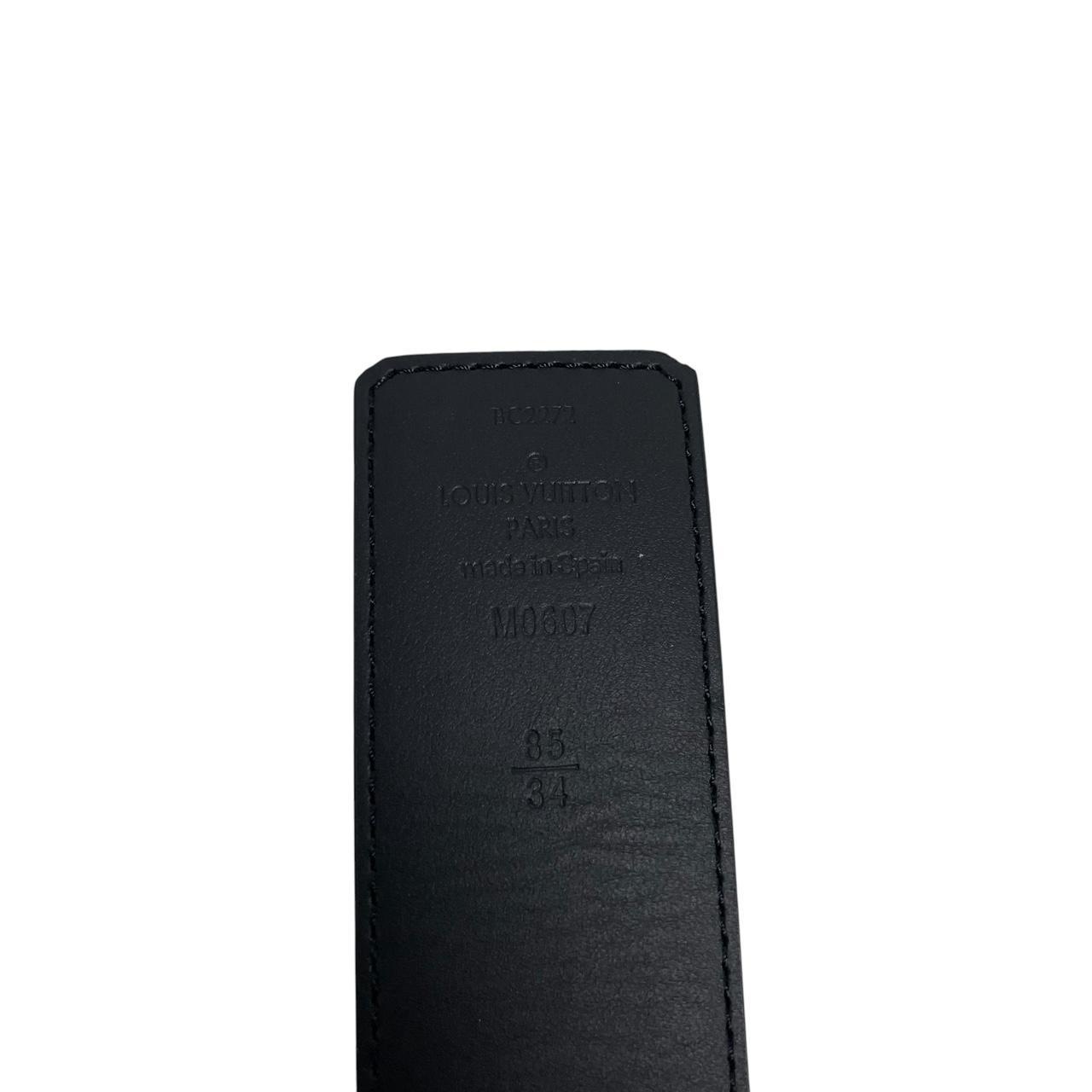 Louis Vuitton black canvas belt with LV monogram pattern and gold-tone buckle.