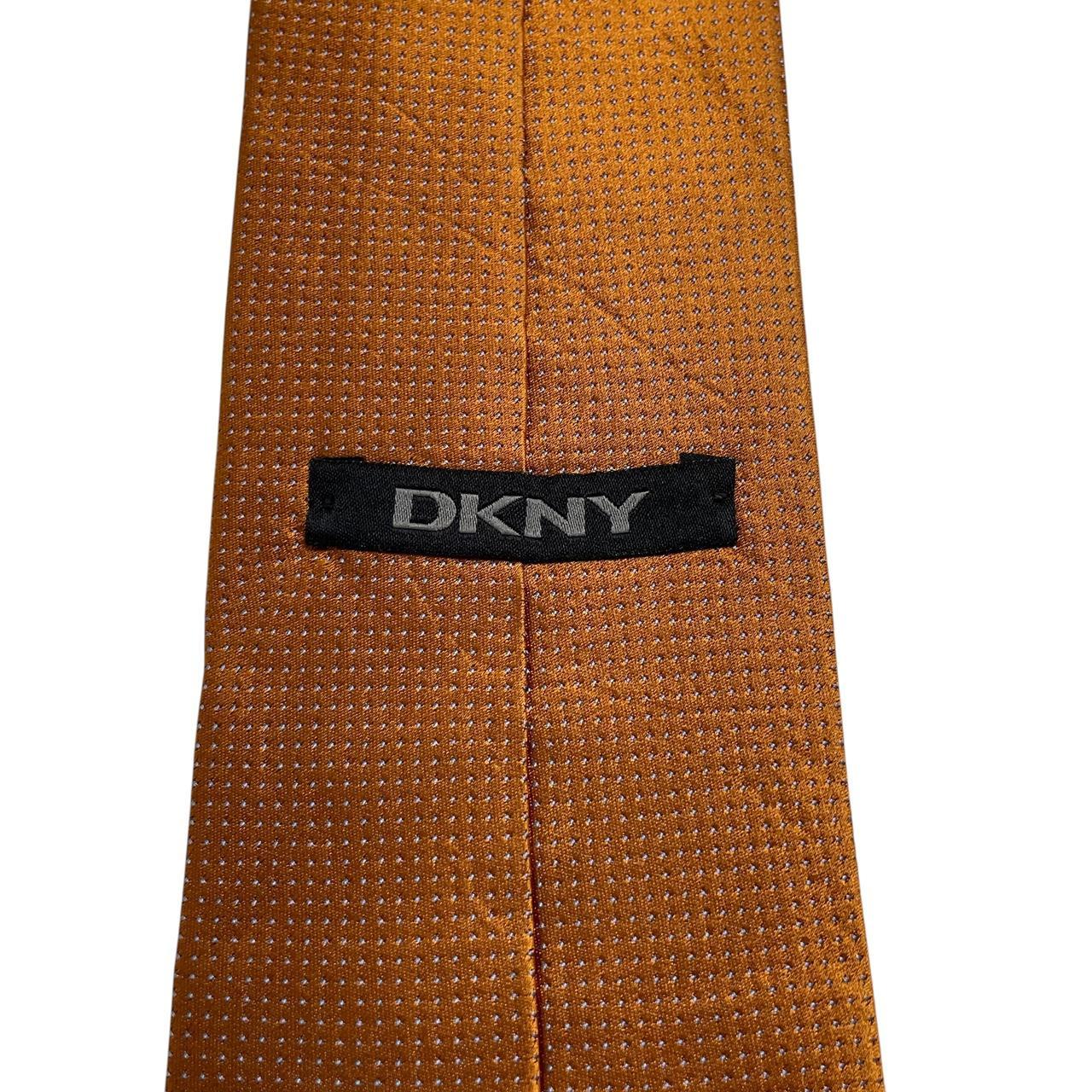 DKNY vintage silk tie in mustard brown with subtle sheen and classic design.