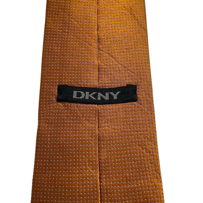 DKNY vintage silk tie in mustard brown with subtle sheen and classic design.