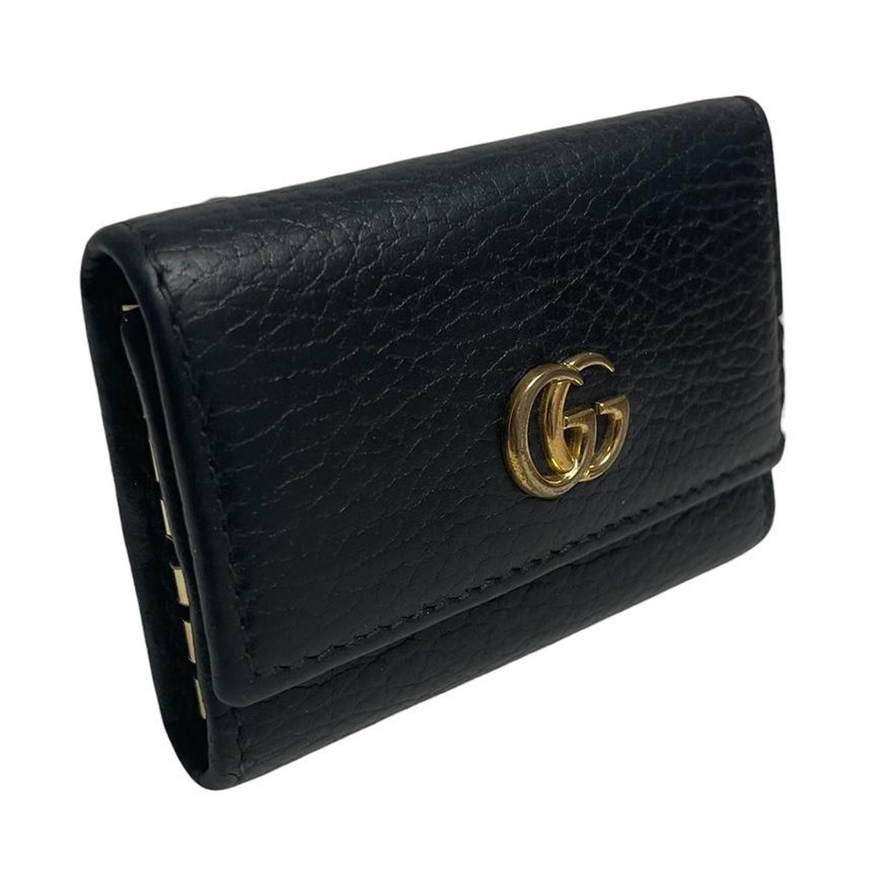 Gucci black leather key case with GG logo and quilted pattern.