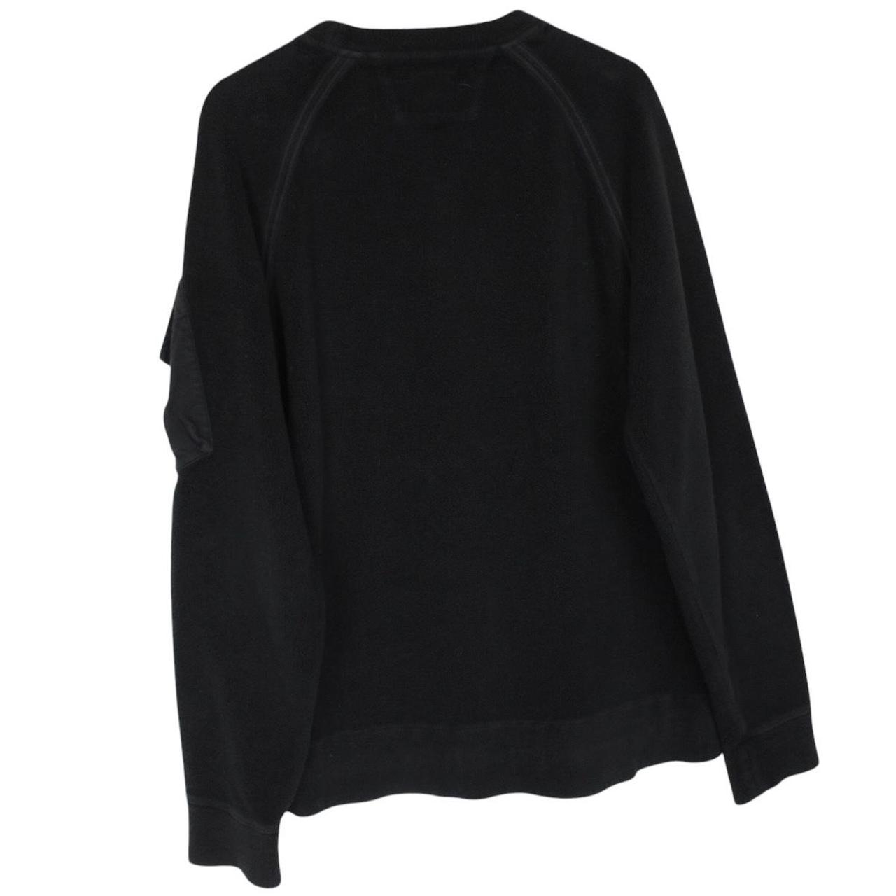 CP Company black fleece jumper with raglan sleeves and iconic lens detail.