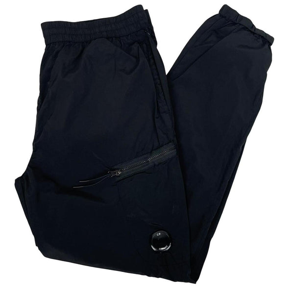 CP Company black cargo trousers with lens detail and nylon material.