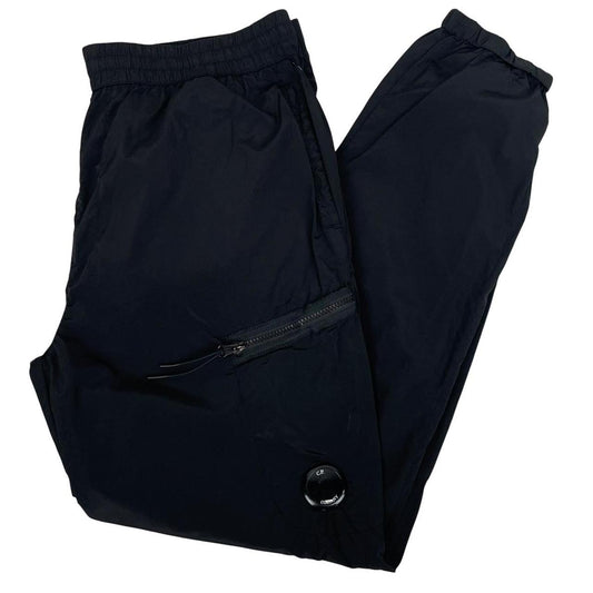 CP Company black cargo trousers with lens detail and nylon material.