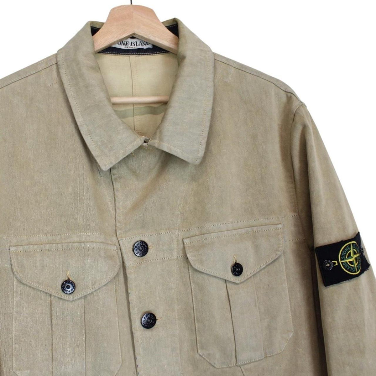 Stone Island beige multi-pocket jacket with logo patch and linen material.