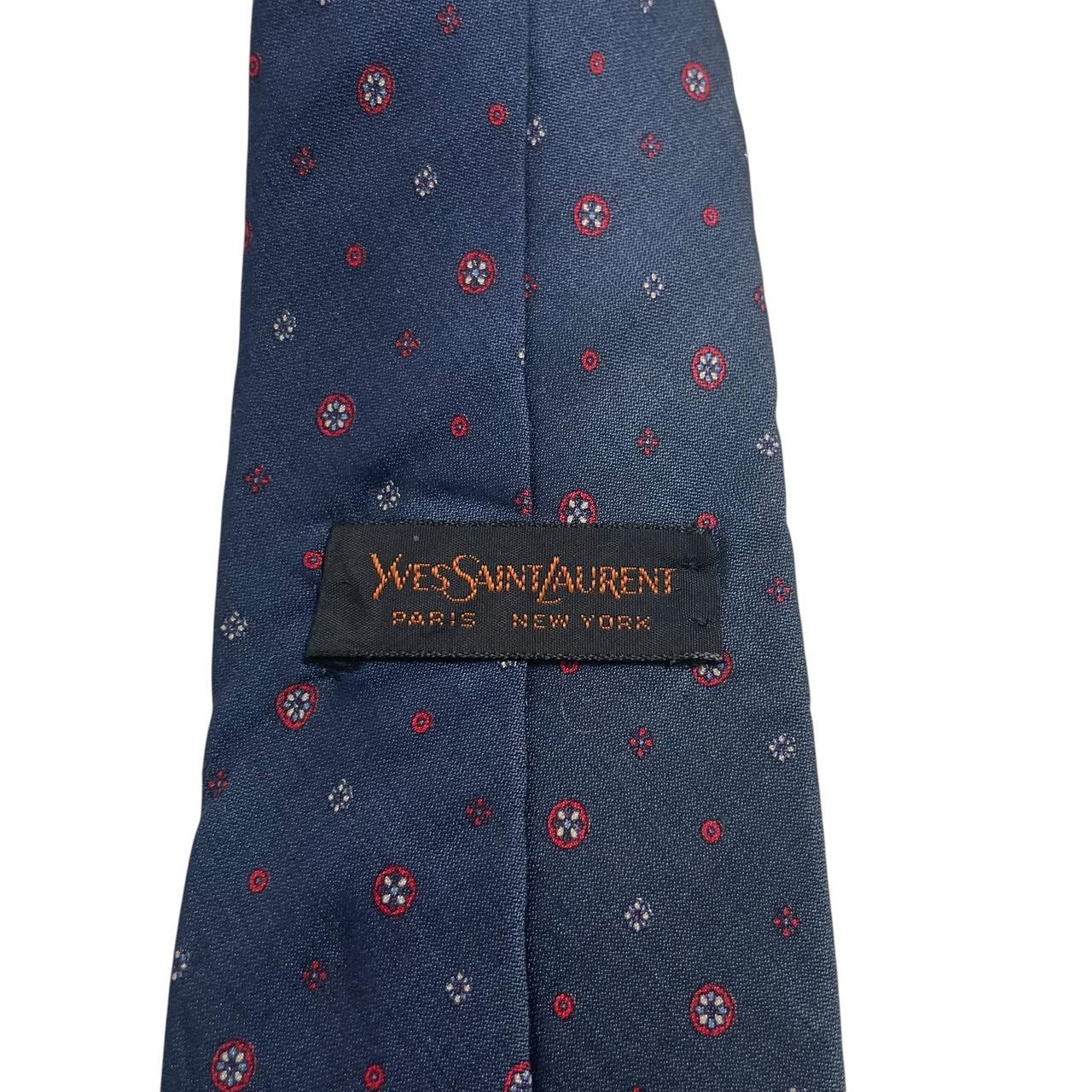 Yves Saint Laurent navy blue silk tie with subtle sheen and classic design.