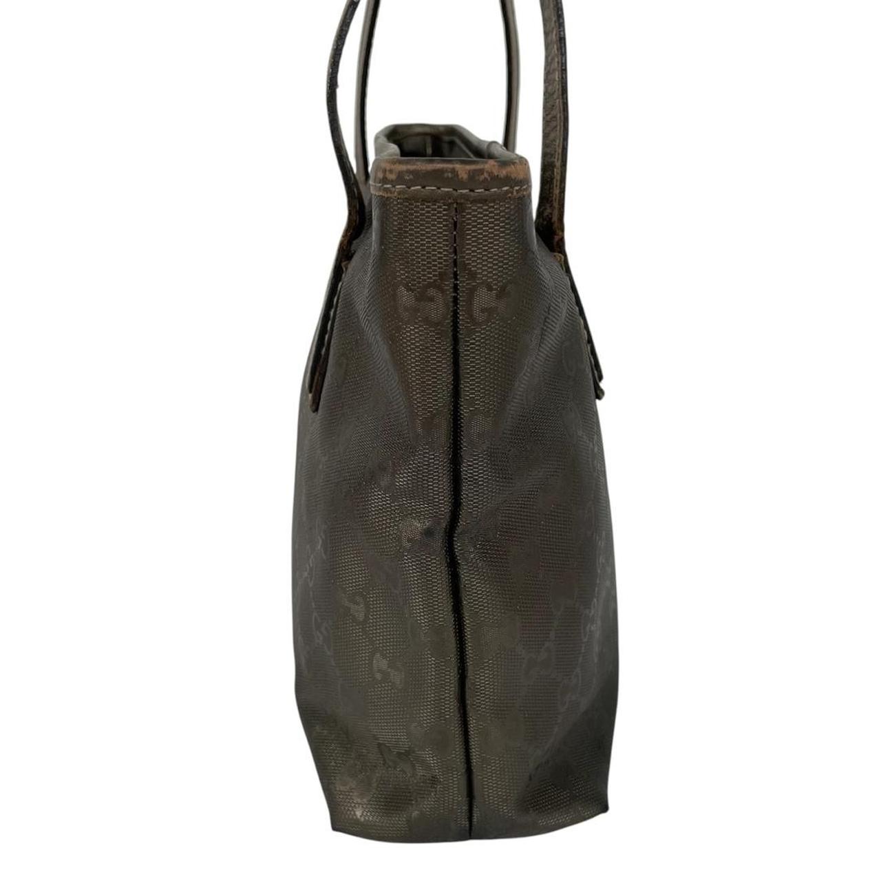 Gucci khaki green duffel bag with metallic monogram canvas and leather trim details.