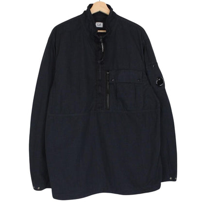 CP Company navy blue jacket 1/4 zip with lens detail and flat nylon material.