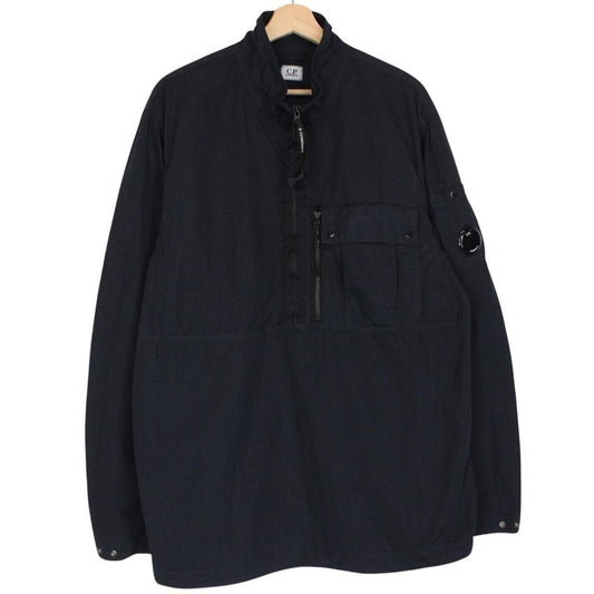 CP Company navy blue jacket 1/4 zip with lens detail and flat nylon material.