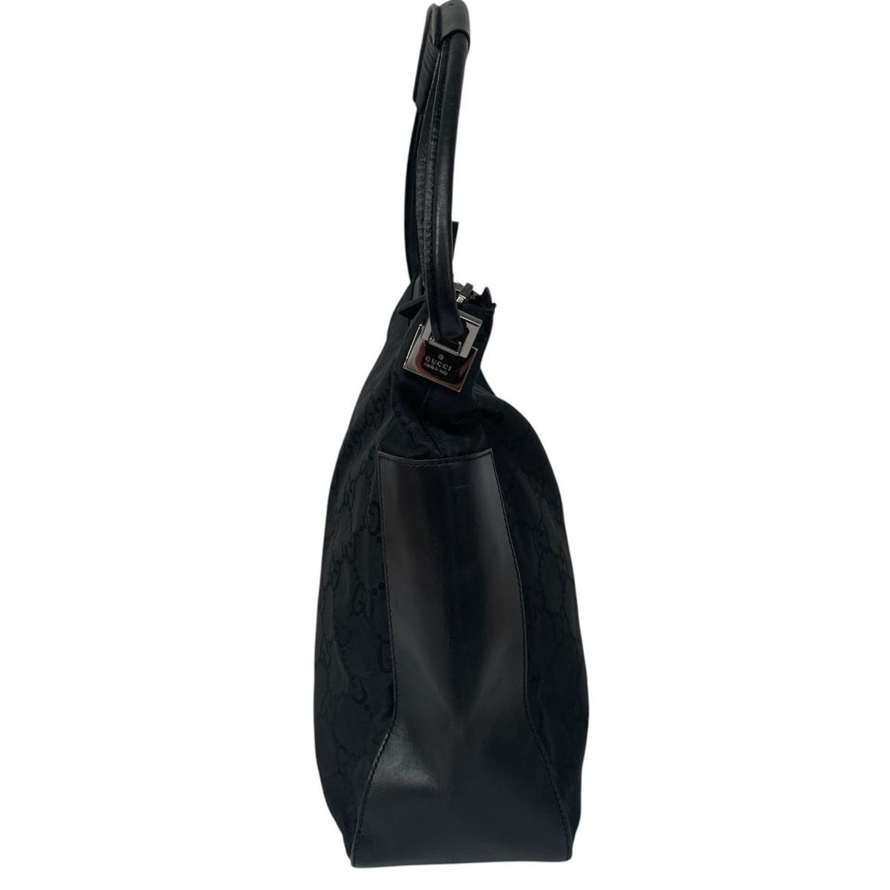 Gucci black hobo shoulder bag with monogram canvas and leather detailing.