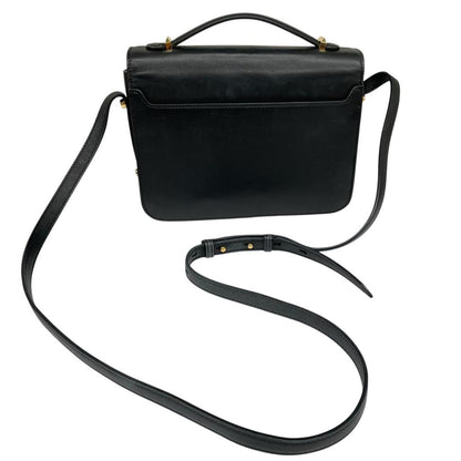 Alexander McQueen black and gold leather messenger bag with logo detailing and faint scratches.