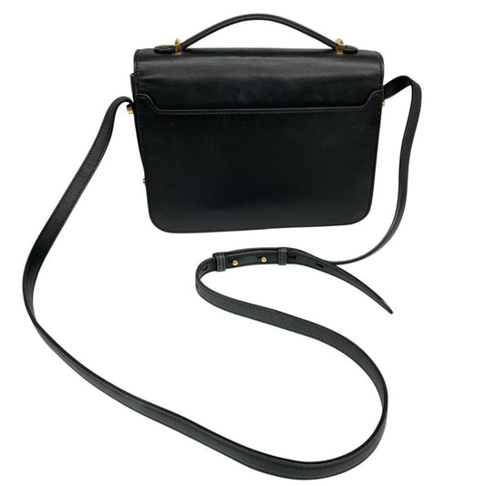 Alexander McQueen black and gold leather messenger bag with logo detailing and faint scratches.
