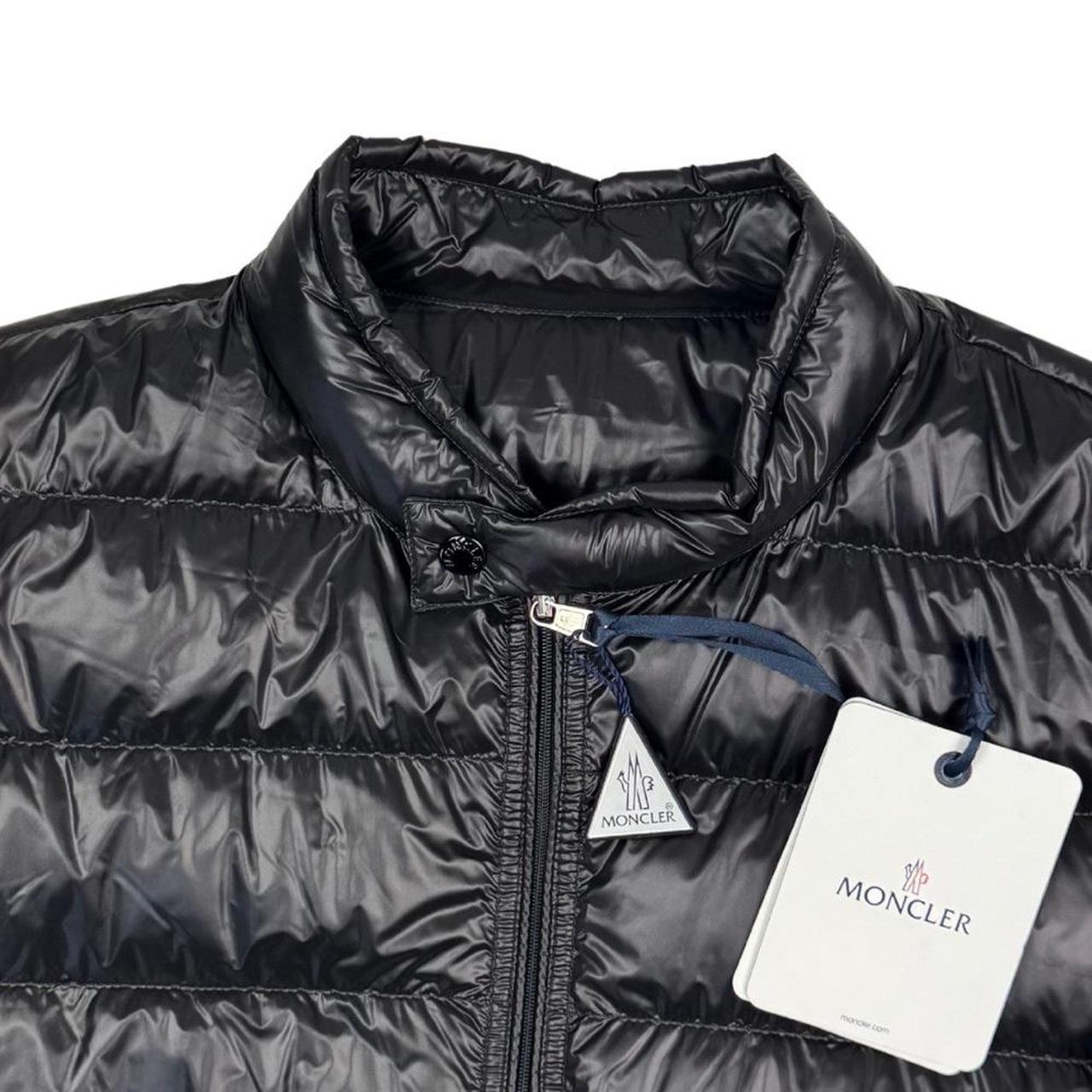 Moncler black nylon down jacket with full zip and logo patch on sleeve.