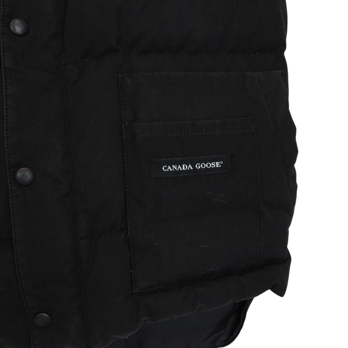 Canada Goose black down gilet with logo patch and durable exterior shell.