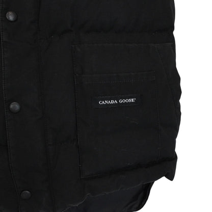 Canada Goose black down gilet with logo patch and durable exterior shell.