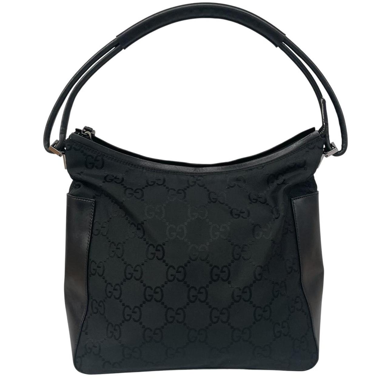 Gucci black hobo shoulder bag with monogram canvas and leather detailing.