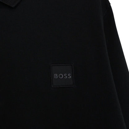 Hugo Boss black long sleeve polo shirt, slim fit, cotton material, subtle wear marks.