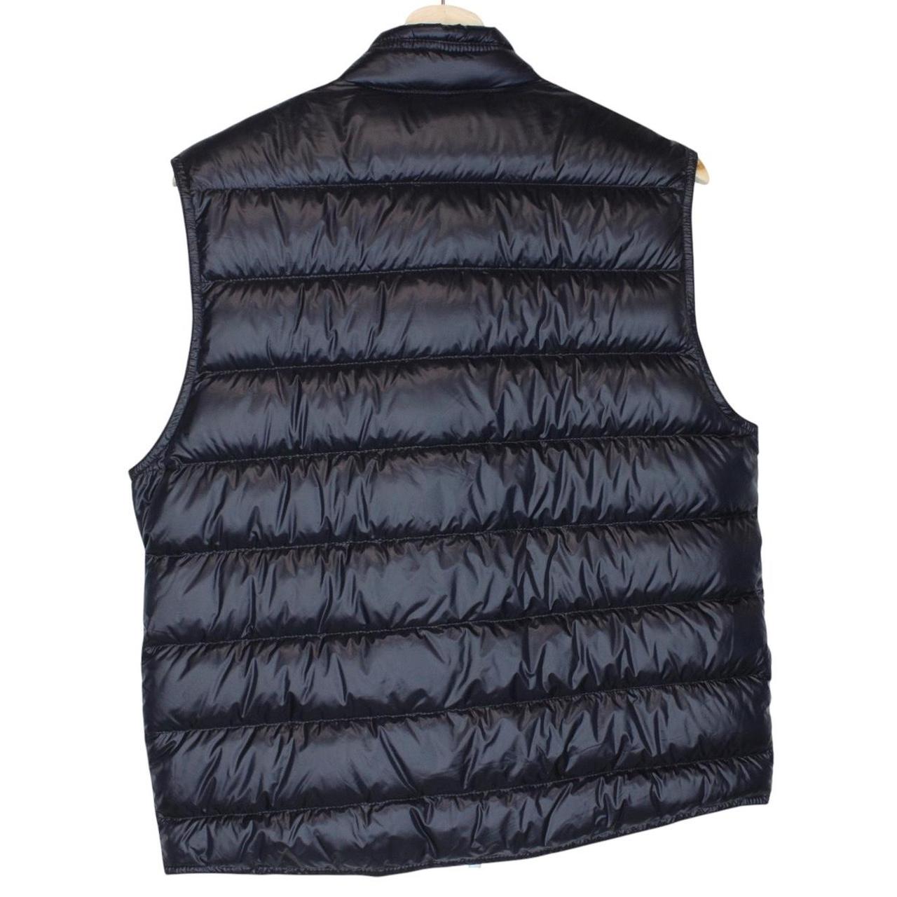 Moncler navy blue down gilet with logo patch and quilted design.