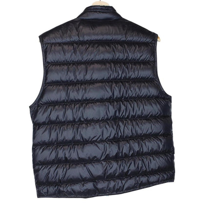 Moncler navy blue down gilet with logo patch and quilted design.