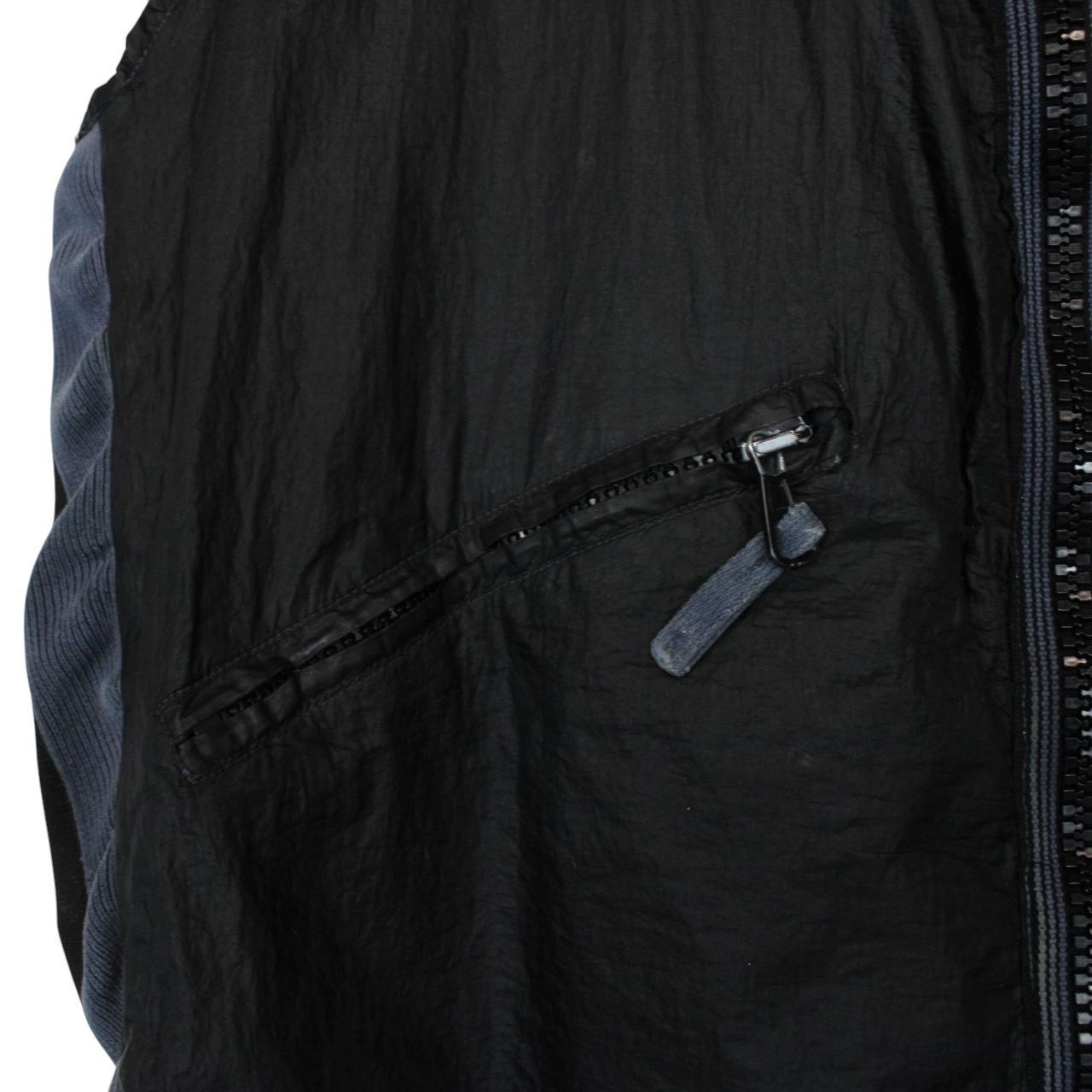 Stone Island navy blue reversible vest with green edge and logo patch detail.