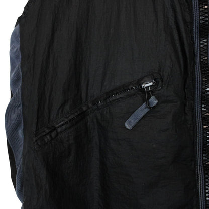 Stone Island navy blue reversible vest with green edge and logo patch detail.