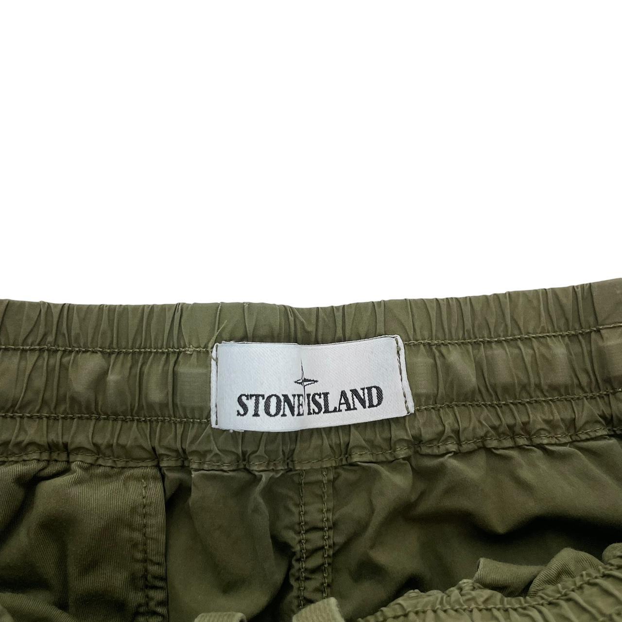 Stone Island khaki green cargo trousers with logo patch and multiple pockets.