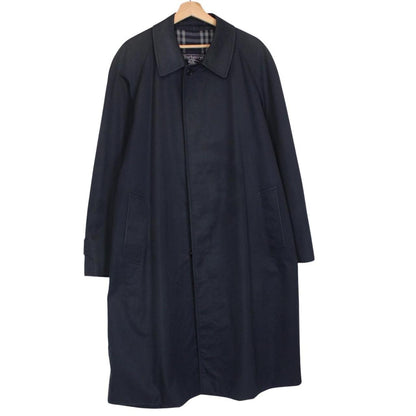 Burberry navy blue trench coat featuring classic Nova Check pattern and single-breasted design.