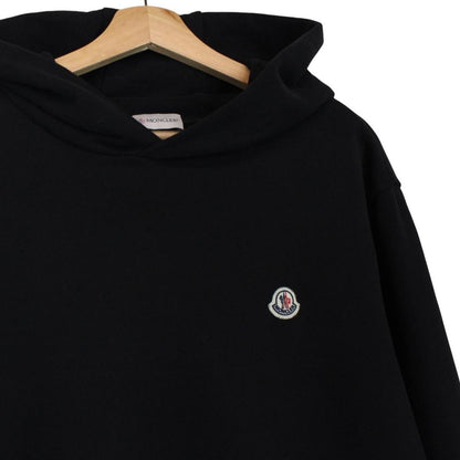 Moncler black hoodie jumper featuring logo patch and cotton material.