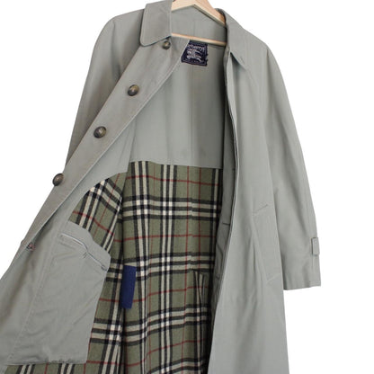 Burberry green trench coat with Nova Check pattern and single-breasted design.
