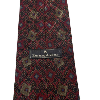 Ermenegildo Zegna burgundy silk tie with abstract print design and logo detail.