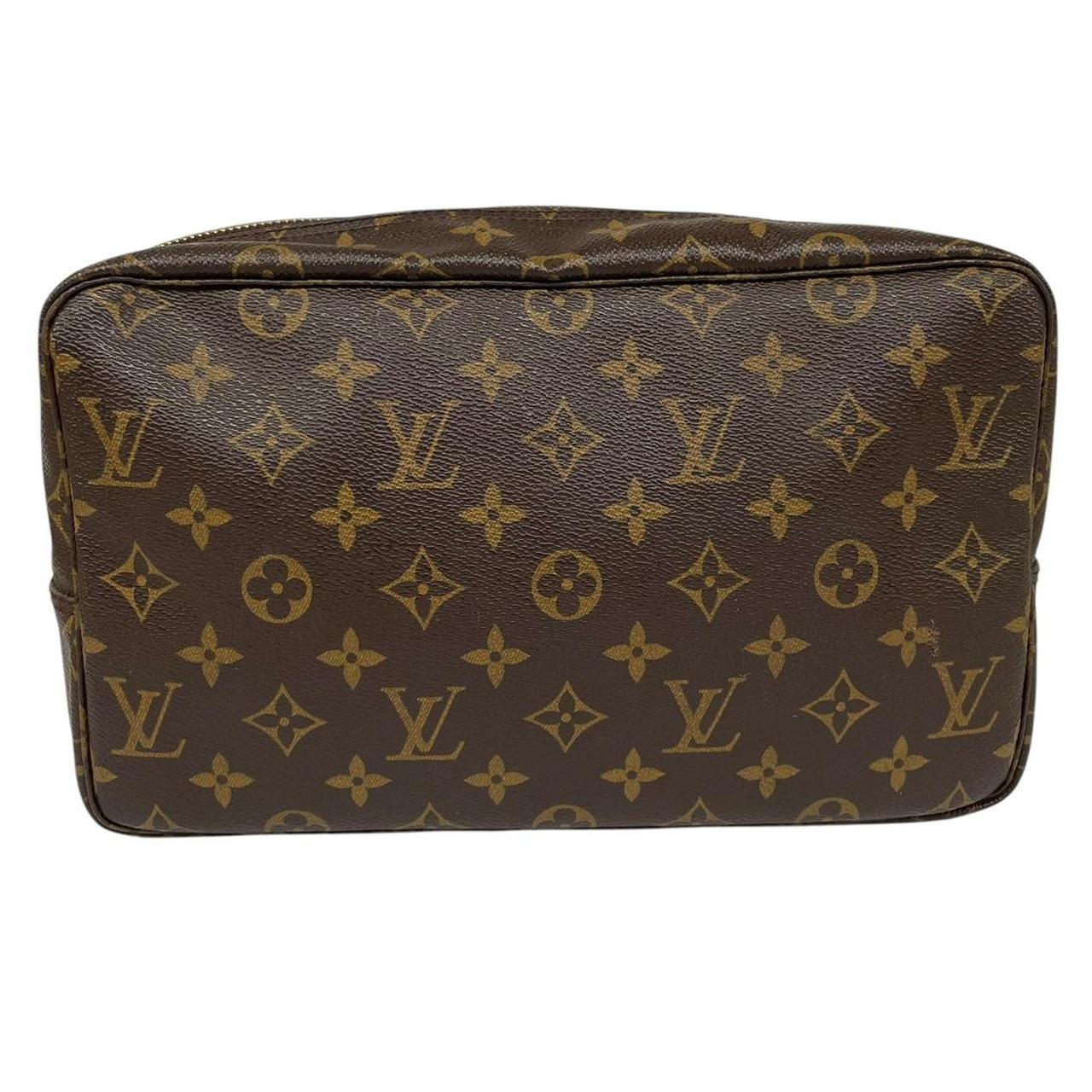 Louis Vuitton brown and tan monogram toiletry pouch with iconic logo and canvas material.