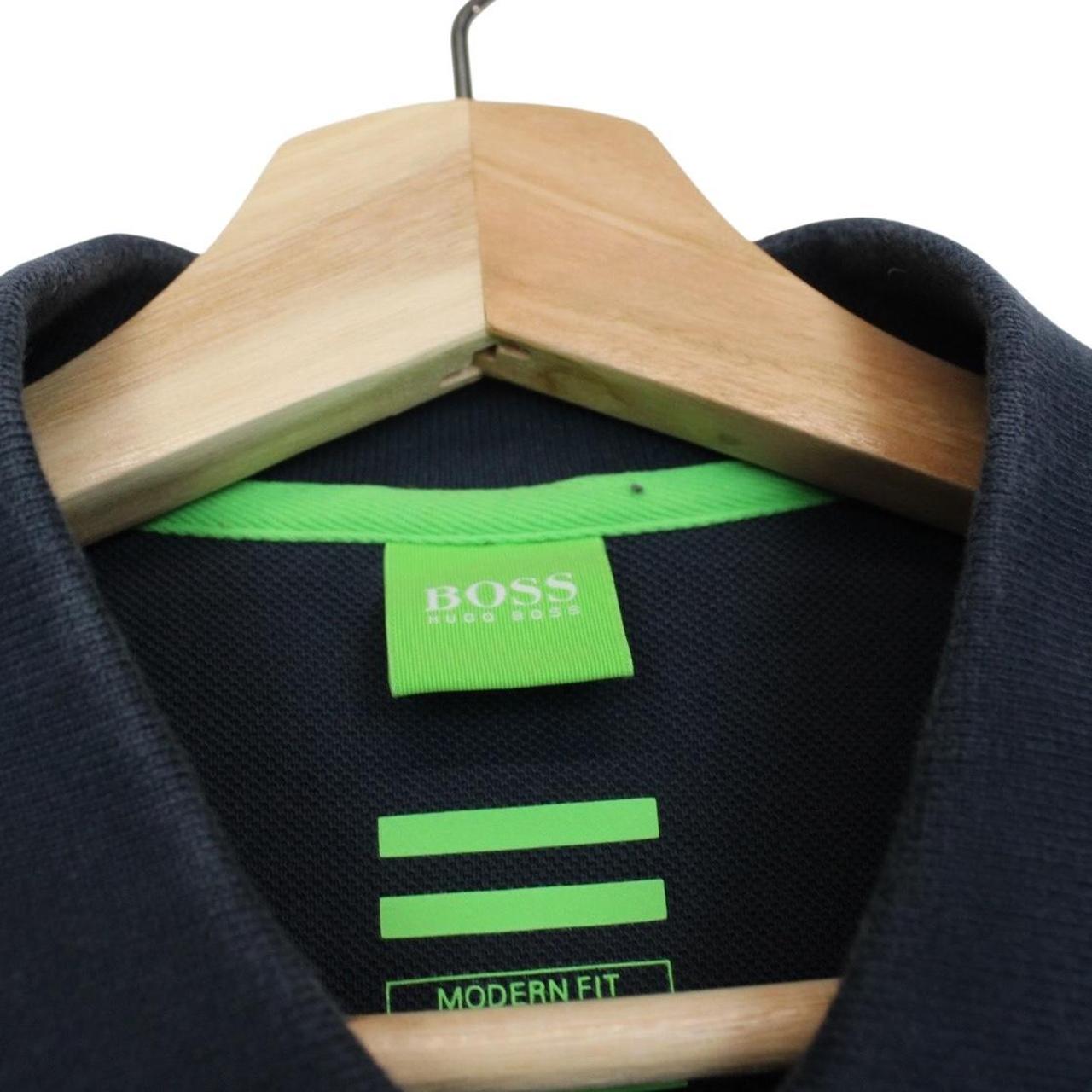 Hugo Boss navy blue short sleeve polo shirt with embroidered logo and cotton material.