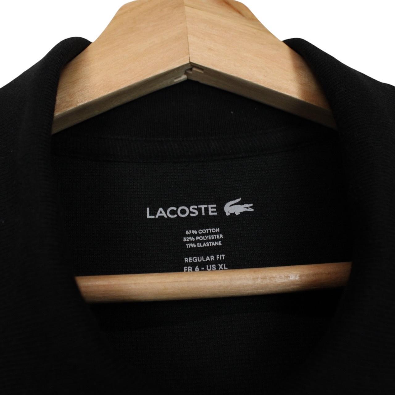 Lacoste black short sleeve polo shirt with embroidered crocodile logo, made of cotton.