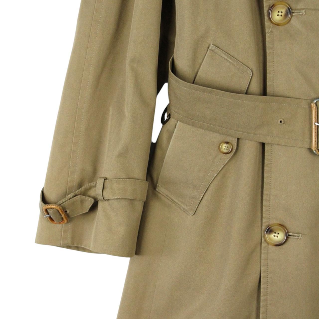 Burberry brown double breasted belted trench coat with classic check lining and logo details.