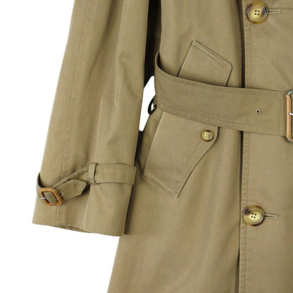 Burberry brown double breasted belted trench coat with classic check lining and logo details.