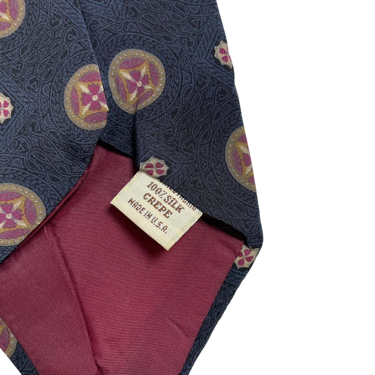 Yves Saint Laurent navy blue silk tie with abstract print design.
