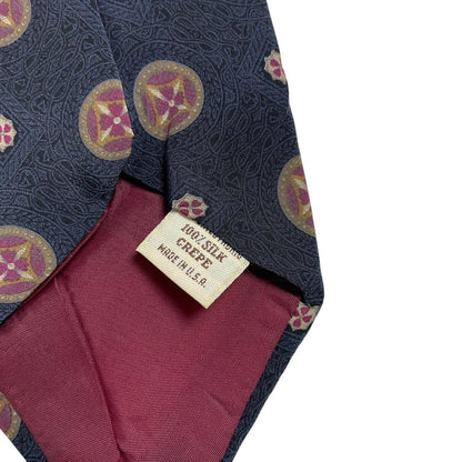 Yves Saint Laurent navy blue silk tie with abstract print design.
