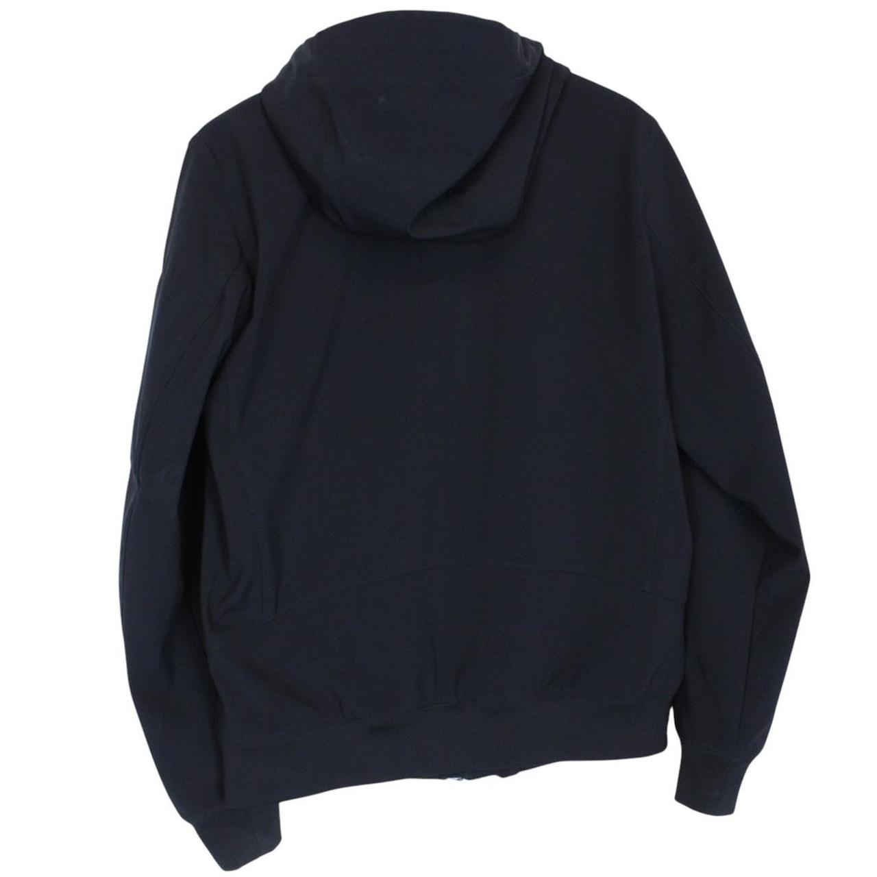CP Company navy blue goggle jacket with full zip and soft shell material.