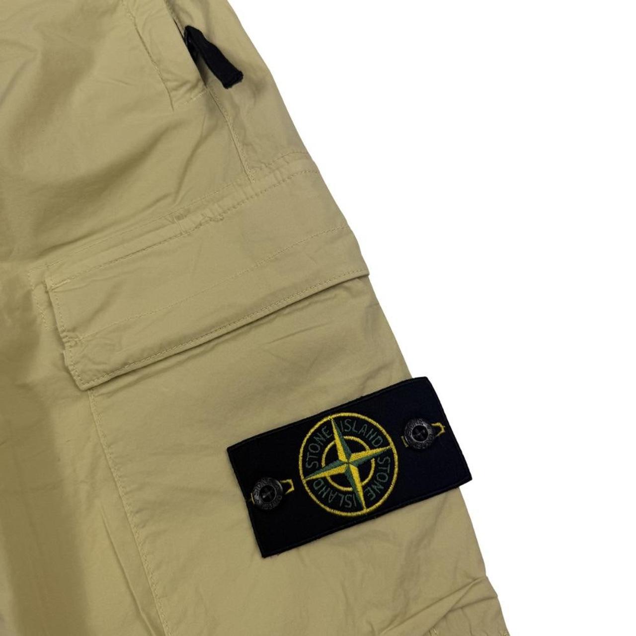 Stone Island beige cargo trousers with logo patch and stretch cotton material.