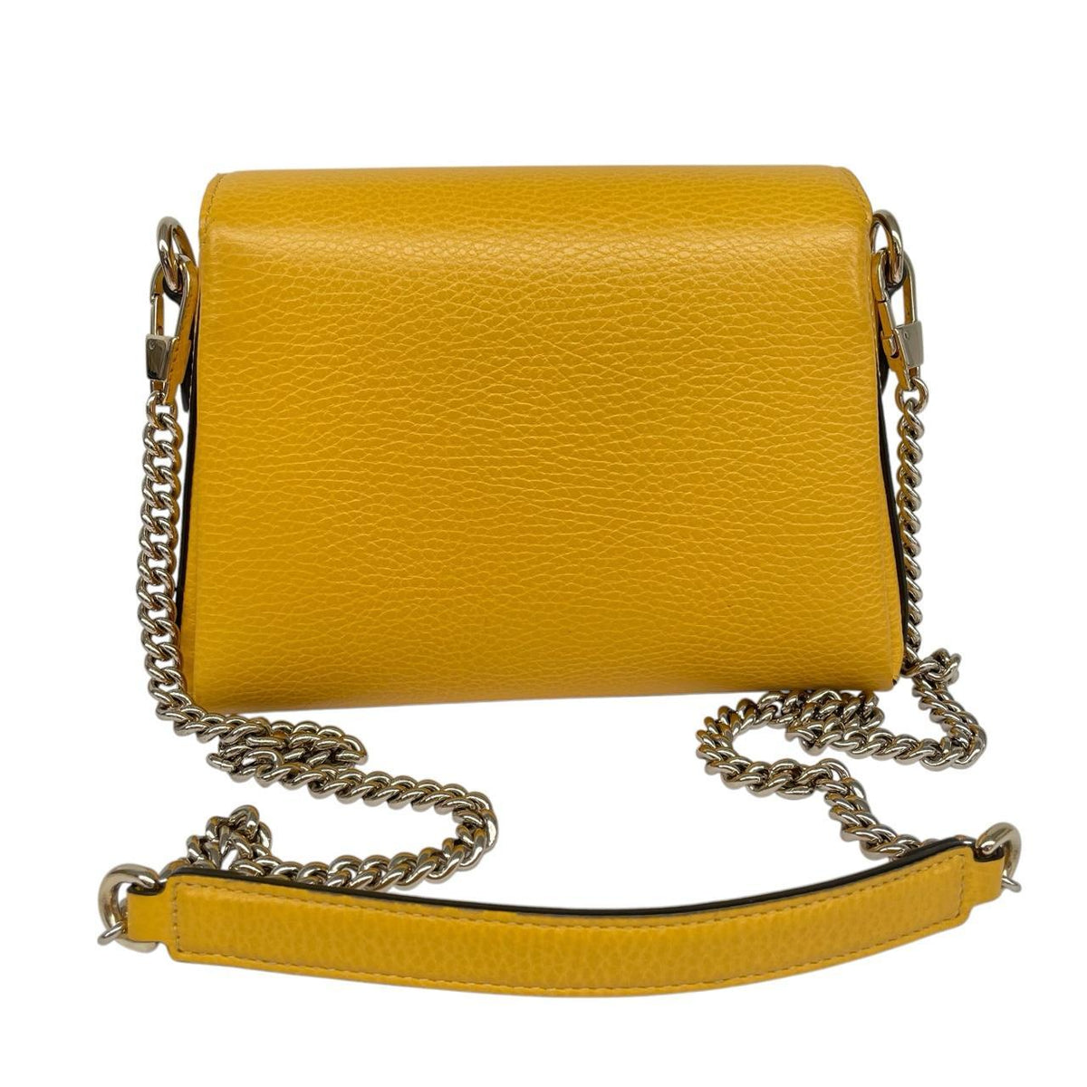 Gucci yellow leather crossbody bag with interlocking G logo and minor metal scratches.