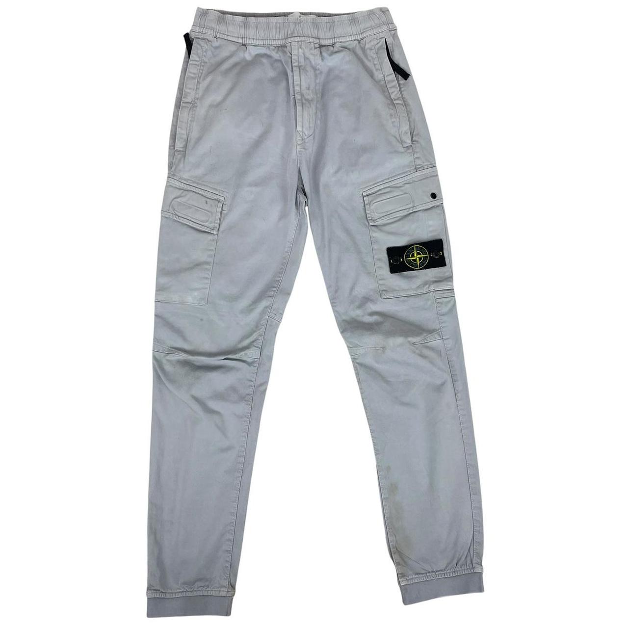 Stone Island blue cargo trousers with logo patch and RE-T fit, visible stain on left leg.