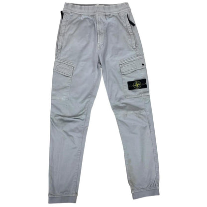 Stone Island blue cargo trousers with logo patch and RE-T fit, visible stain on left leg.