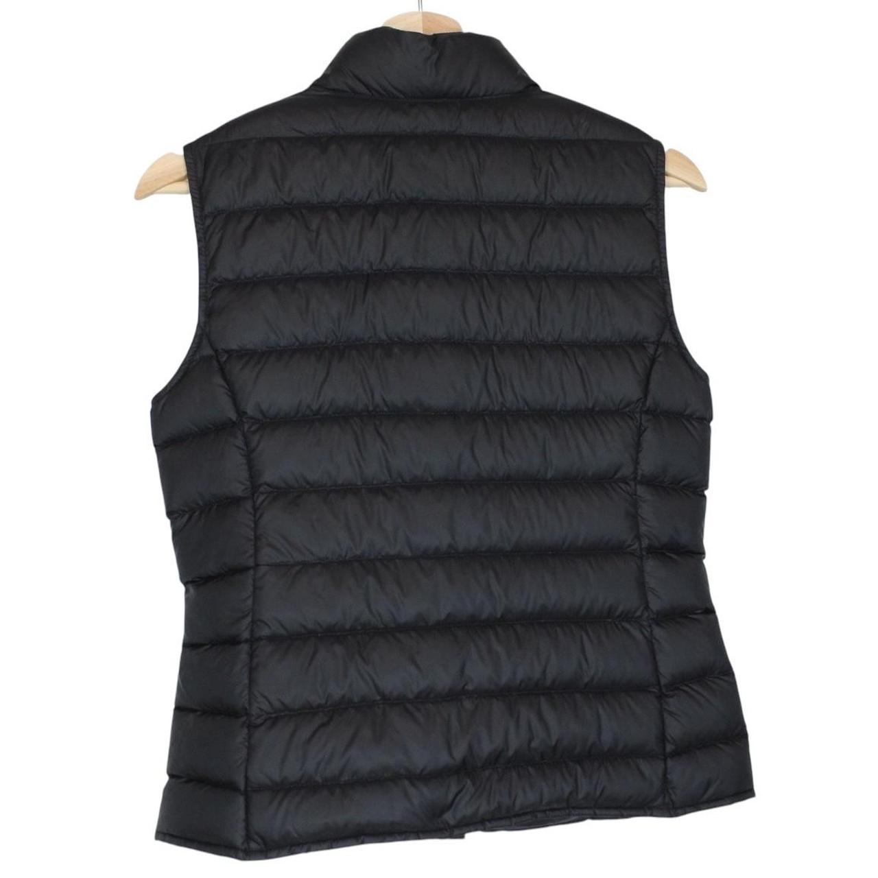Moncler black quilted shell down gilet with logo patch and zip pockets.
