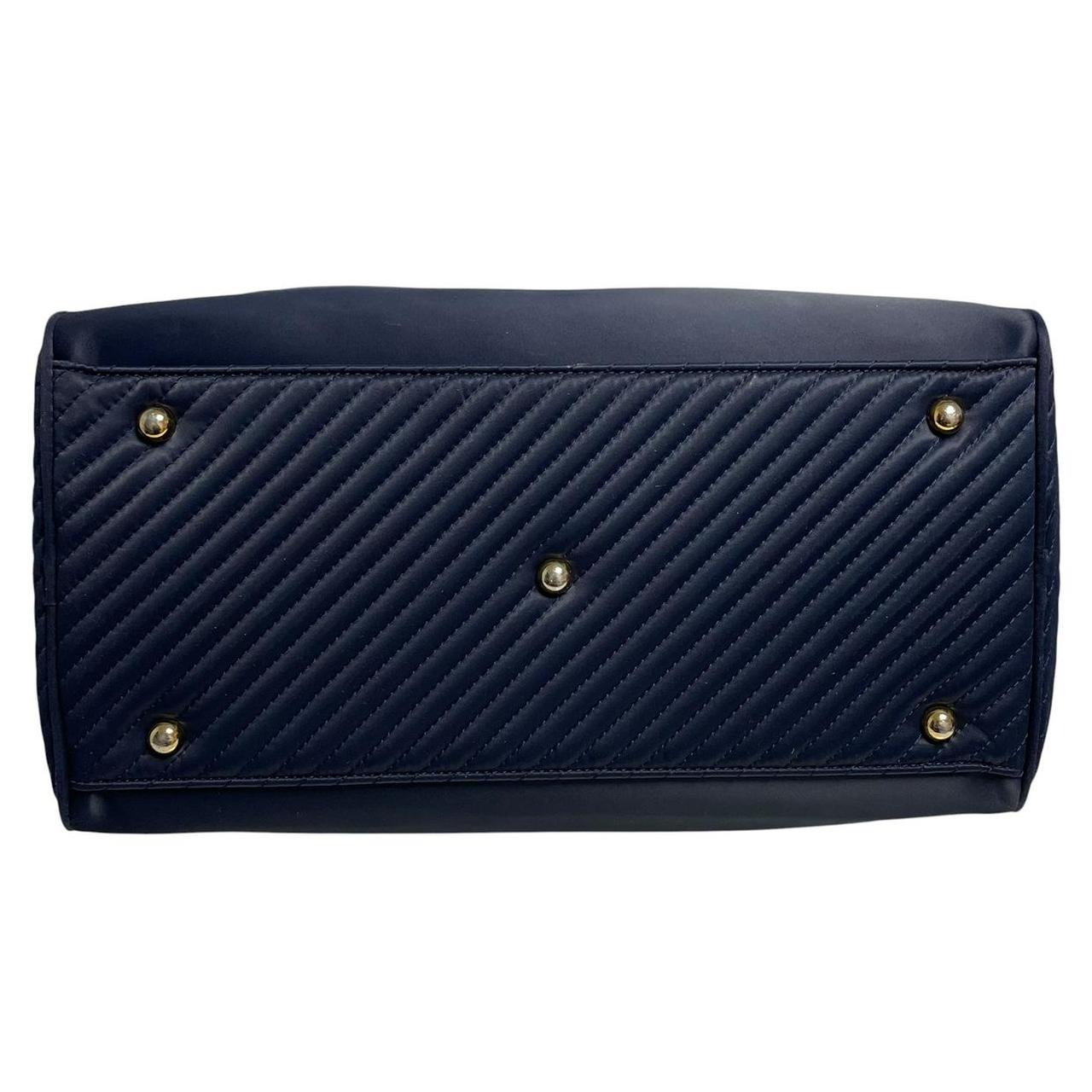 Yves Saint Laurent navy blue duffel bag embossed logo nylon material with handles.